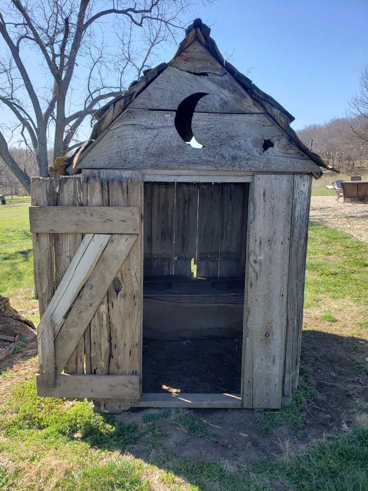 The moon symbol carved into an outhouse door signaled it was for use by women